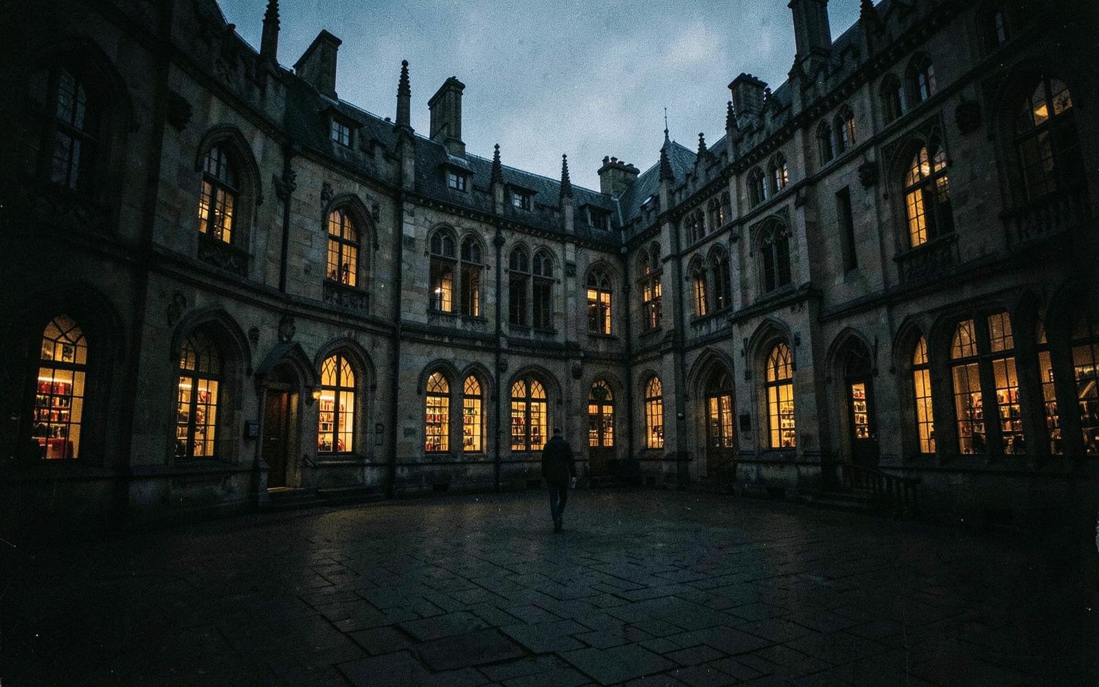 University courtyard at dusk with lit library windows